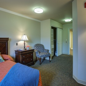 Bedroom with bed, lamp, and nightstand