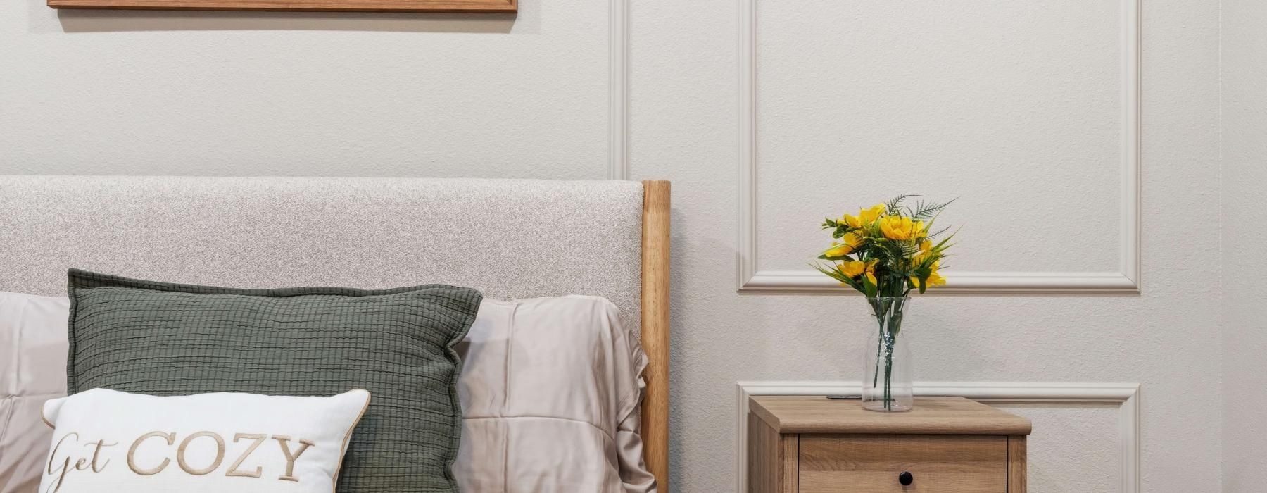 a bed with a flower on a bed stand