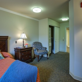 Bedroom with bed, lamp, and nightstand